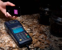 Photo showing Bling Nation's Bling Tag working with the Bling Box and an iPhone. Wireless NFC payments get real.